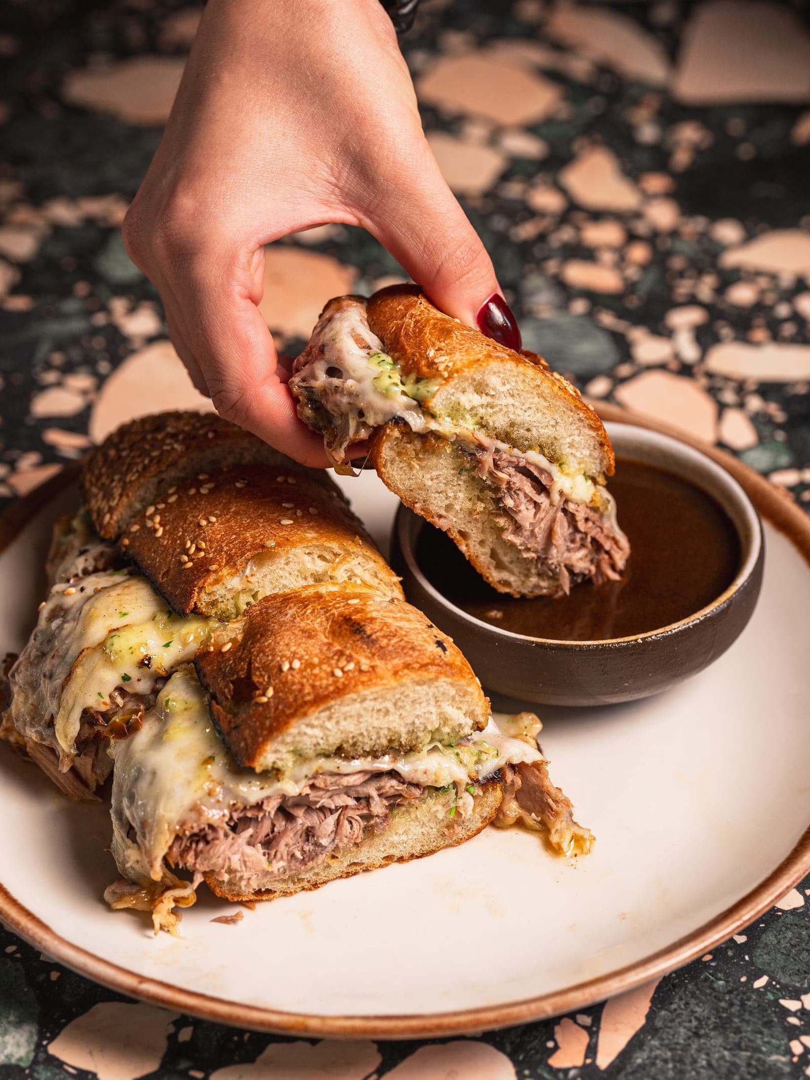 A roast pork sandwich dipped in jus