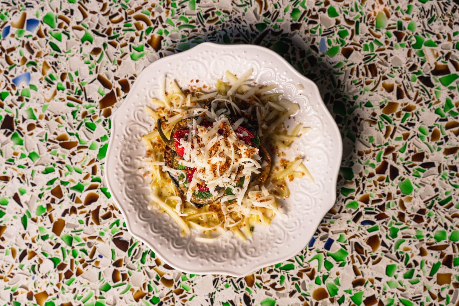 Seasonal vegetable scapece from above, on a terrazzo table