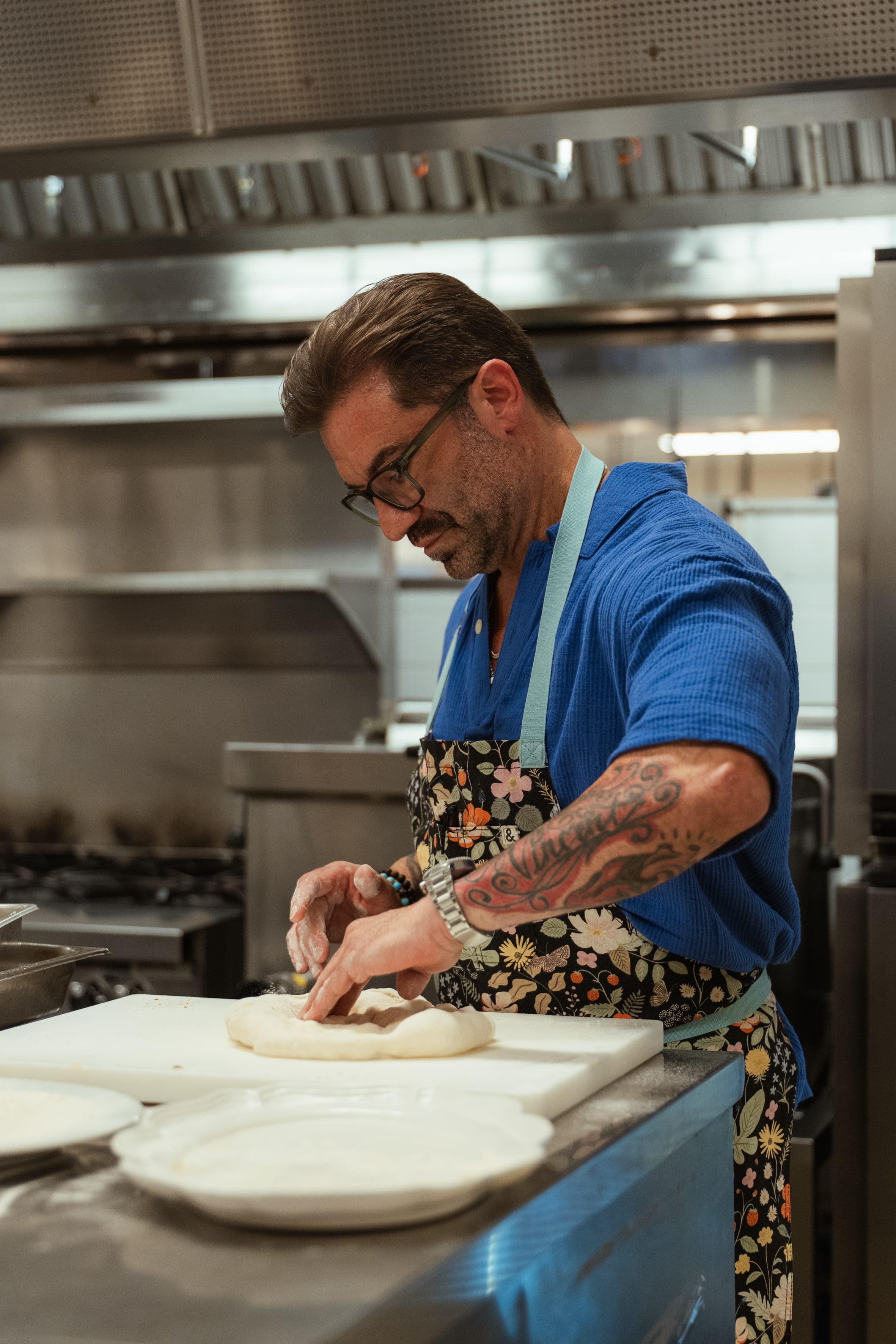 Hands stretching pizza dough